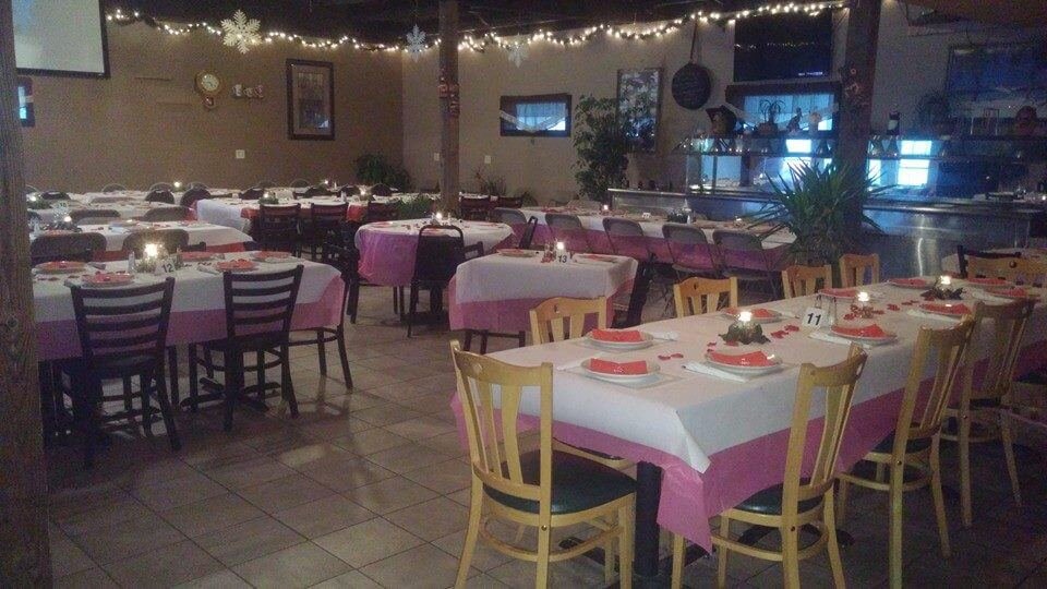 The Gig's Place banquet room set with linens, numbered tables and centerpieces